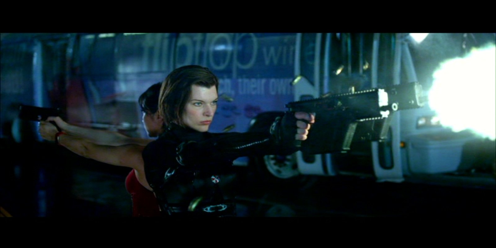 Two characters from the movie Resident Evil: Retribution aim firearms in an intense, dark action scene.