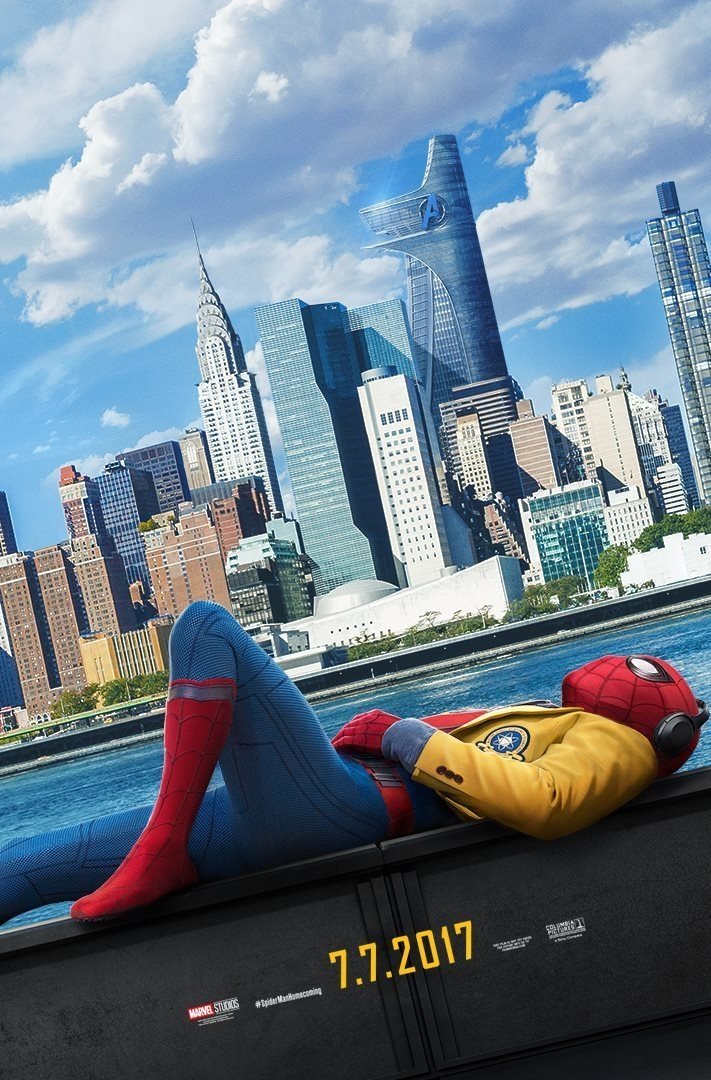 Spider-Man, in a yellow hoodie, relaxes by the water with New York City's skyline in the background, promoting the movie Spider-Man: Homecoming, released on July 7, 2017.