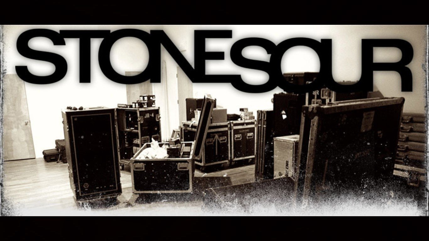 Black and white image of stacked music equipment cases with the band name Stone Sour prominently displayed above.