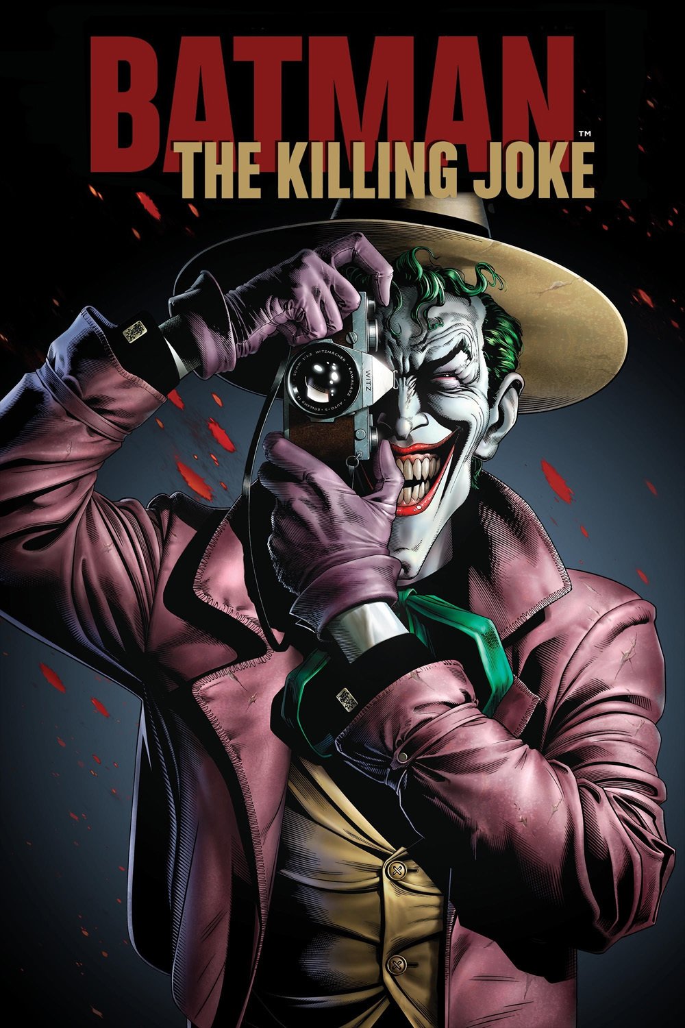 Joker from *Batman: The Killing Joke* holds a camera with a sinister smile, framed against a dark background, embodying his chaotic persona and menacing charm.