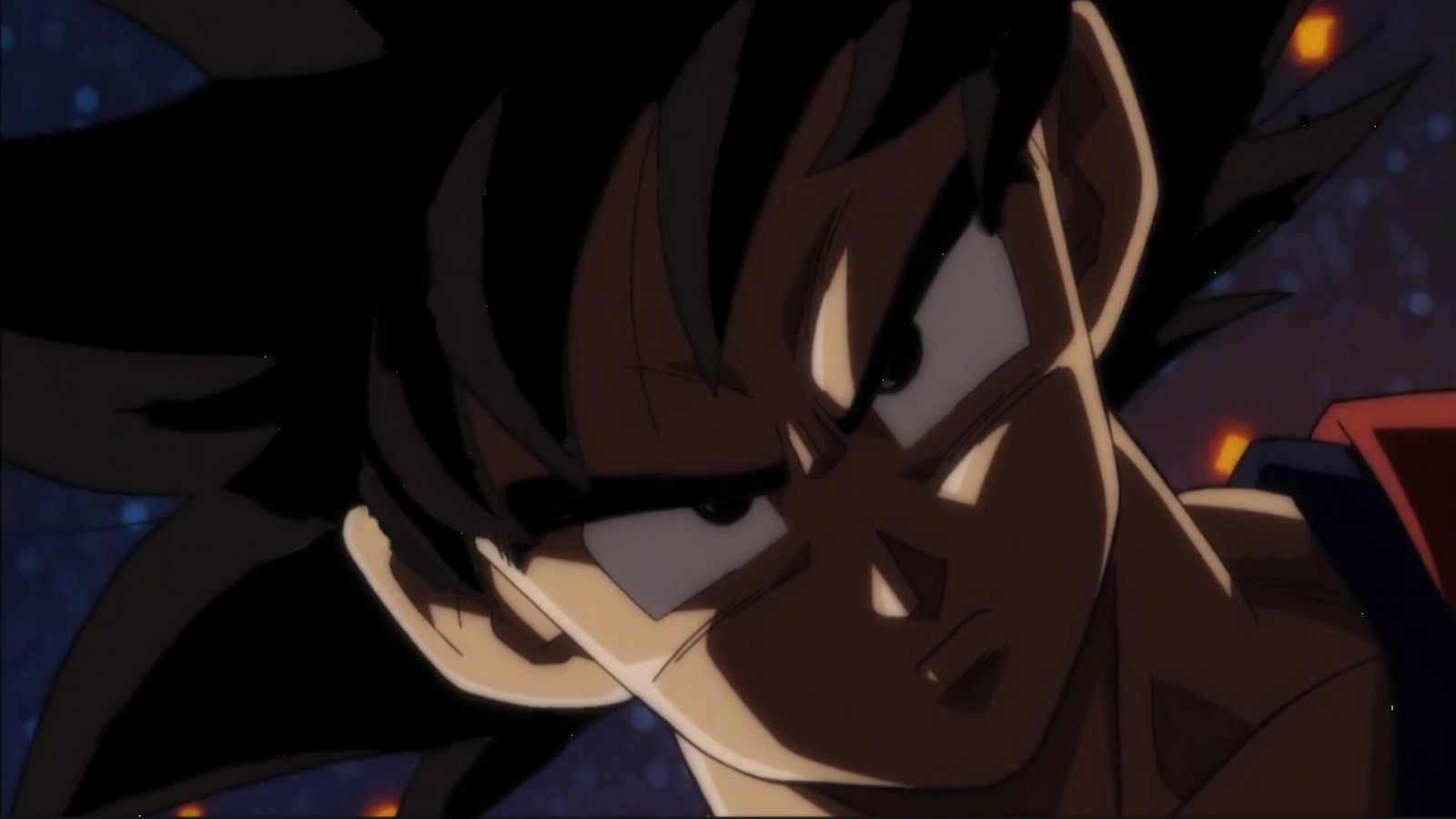 Close-up of Goku from Dragon Ball Super, showcasing his intense expression and spiky hair against a dark, cosmic background.