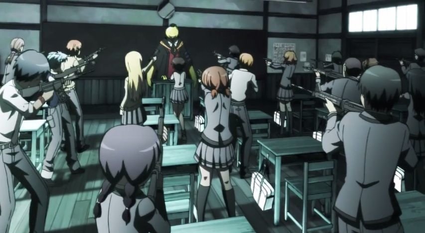 Anime — Assassination Classroom: a yellow octopus-headed teacher stands on a desk while uniformed students in a dim classroom aim weapons at him.