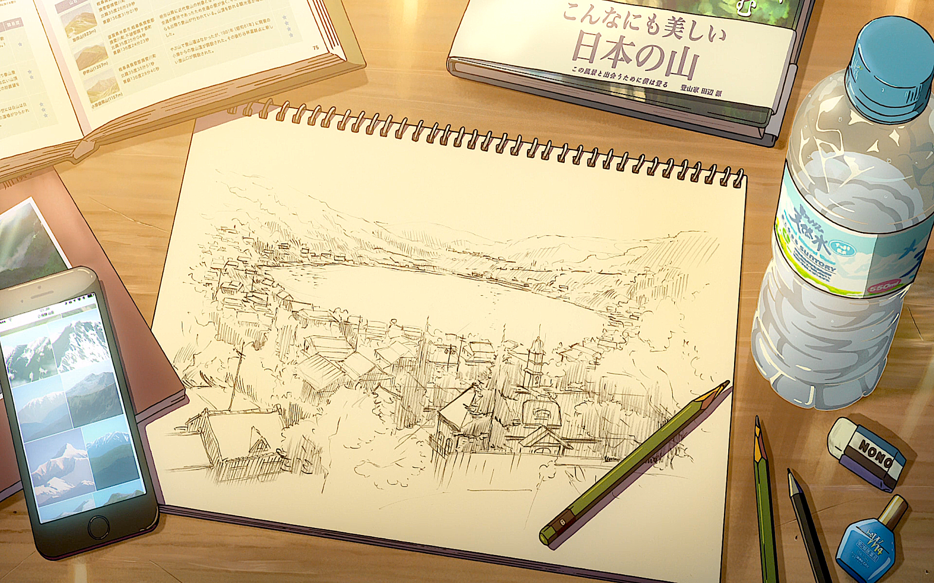 Sketchbook drawing from the anime Your Name., featuring a detailed pencil sketch of a scenic village landscape on a wooden desk with art supplies and a water bottle.