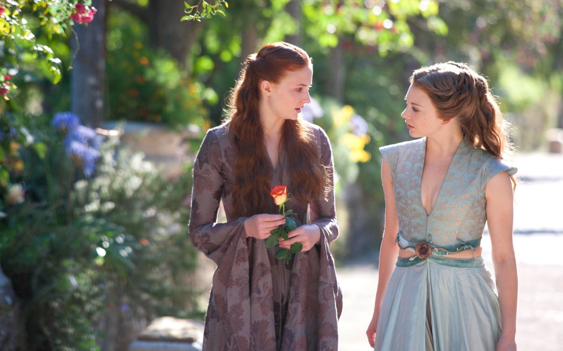 Sophie Turner as Sansa Stark and Natalie Dormer as Margaery Tyrell share a moment outdoors in the TV show Game of Thrones.