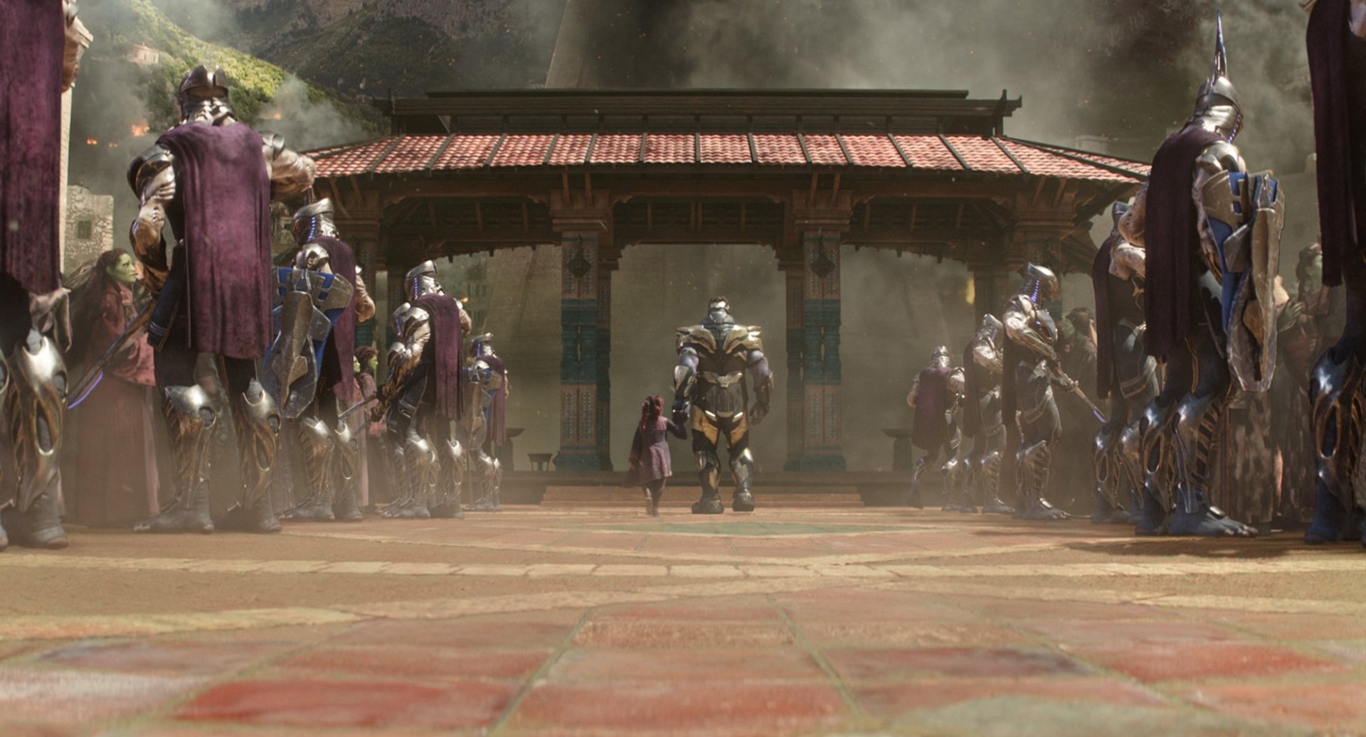 Thanos, played by Josh Brolin, stands alongside Gamora in a tense scene from Avengers: Infinity War, set in a grand hall lined with armored warriors.