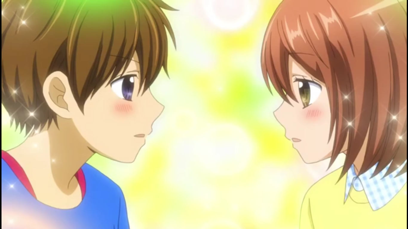 Anime scene of 12-sai Yui Aoi and Kazuma Hiyama blushing as they gaze at each other with soft expressions against a warm, glowing bokeh background.