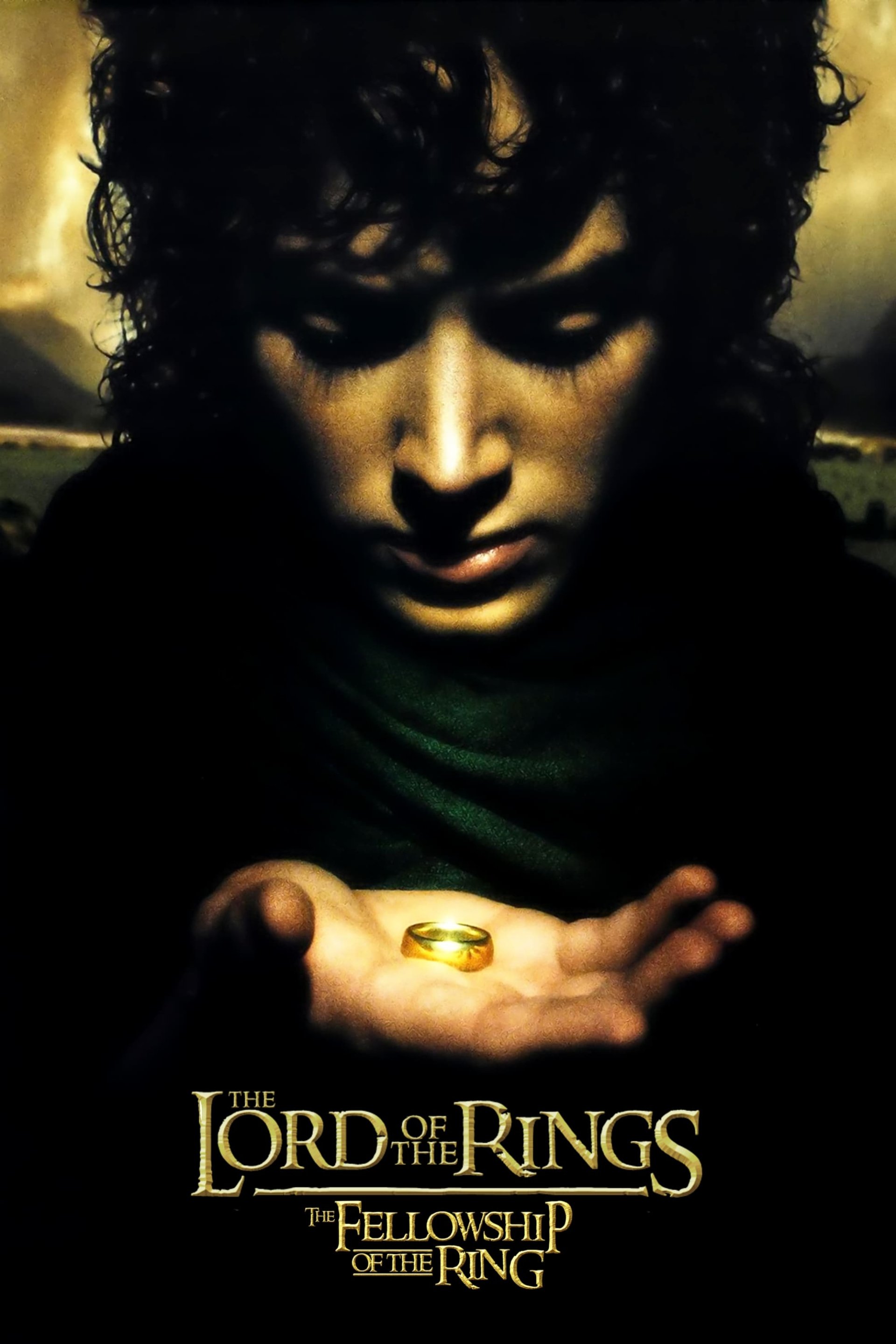 Poster for the movie The Lord of the Rings: The Fellowship of the Ring — a brooding hobbit holds and stares at a glowing gold ring cupped in his palm.
