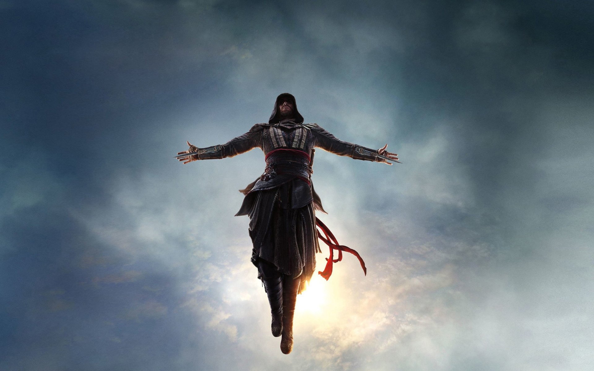 Assassin's Creed movie poster: a hooded assassin in iconic robes levitates with arms outstretched against a glowing, cloud-filled sky.
