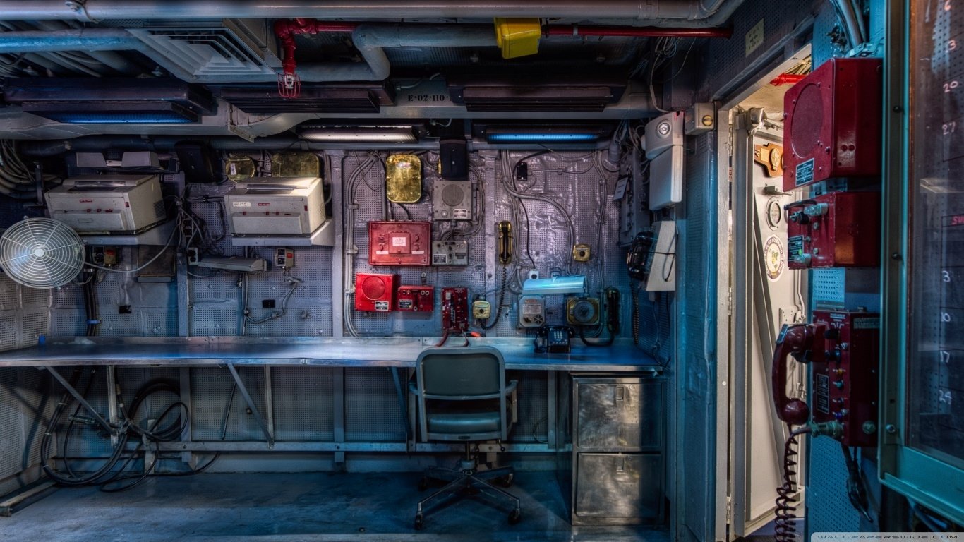 Interior view of the USS Midway (CV-41) showing vintage military communication equipment and control panels inside the aircraft carrier.