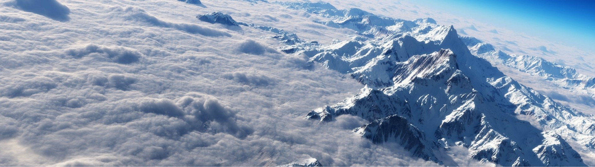 Majestic Mountain Peaks Emerging Above a Sea of Clouds