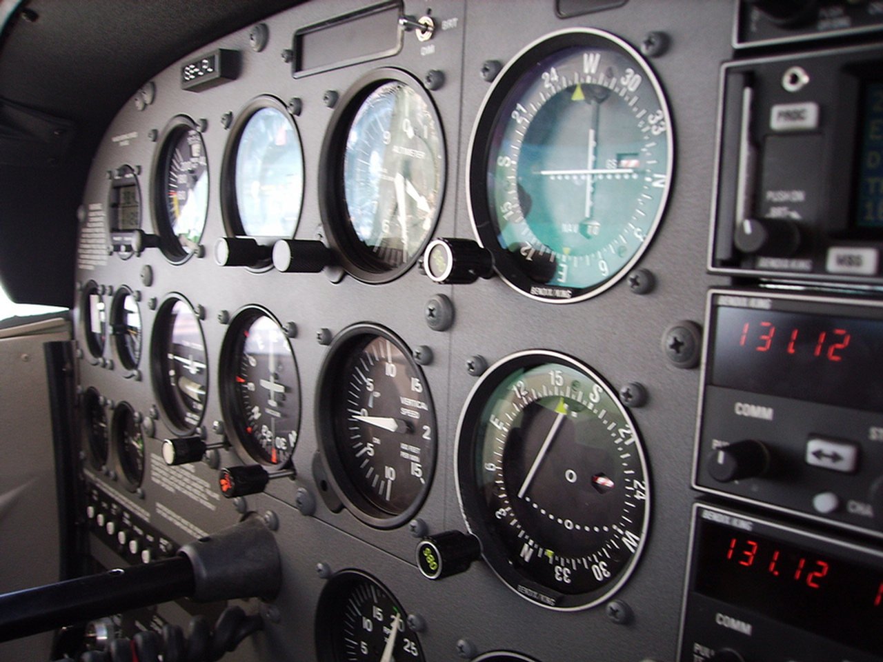 Close-up view of the instrument panel inside a Cessna aircraft, showing various gauges and controls essential for flight operation.