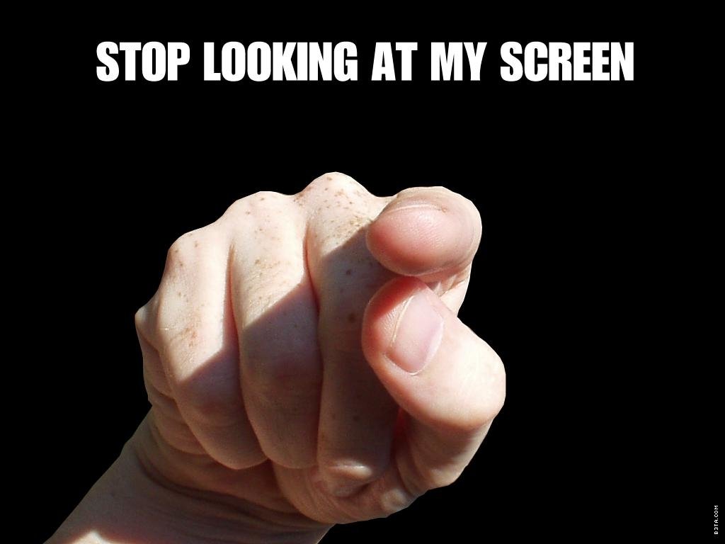 A close-up of a clenched fist against a black background, humorously captioned STOP LOOKING AT MY SCREEN, adds a funny touch to the image.