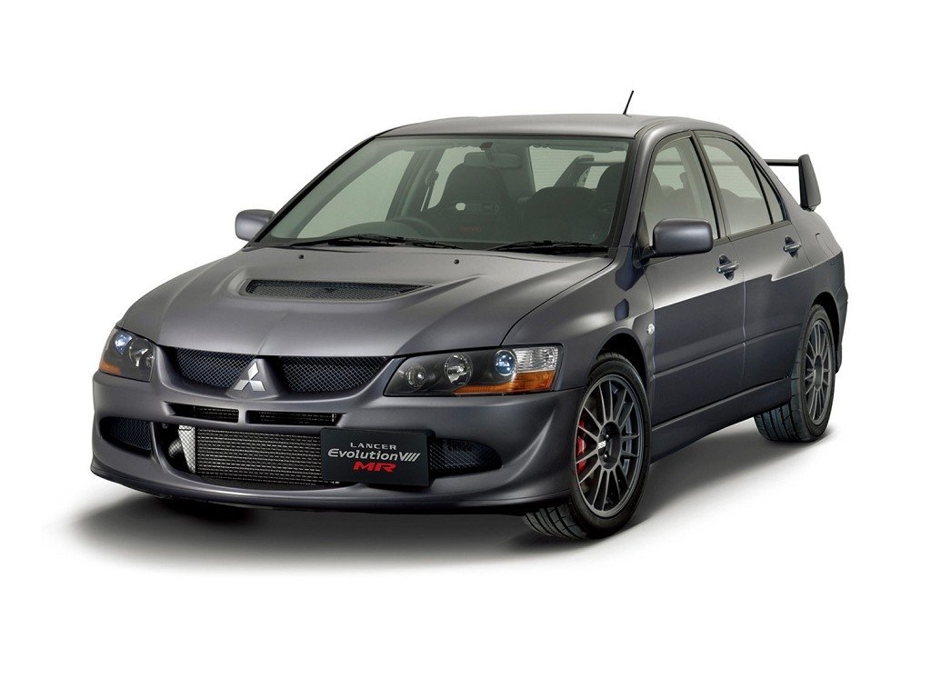 A sleek grey Mitsubishi Lancer Evolution featuring sporty design elements, including a prominent hood scoop and racing wheels, showcasing its performance-oriented appeal.