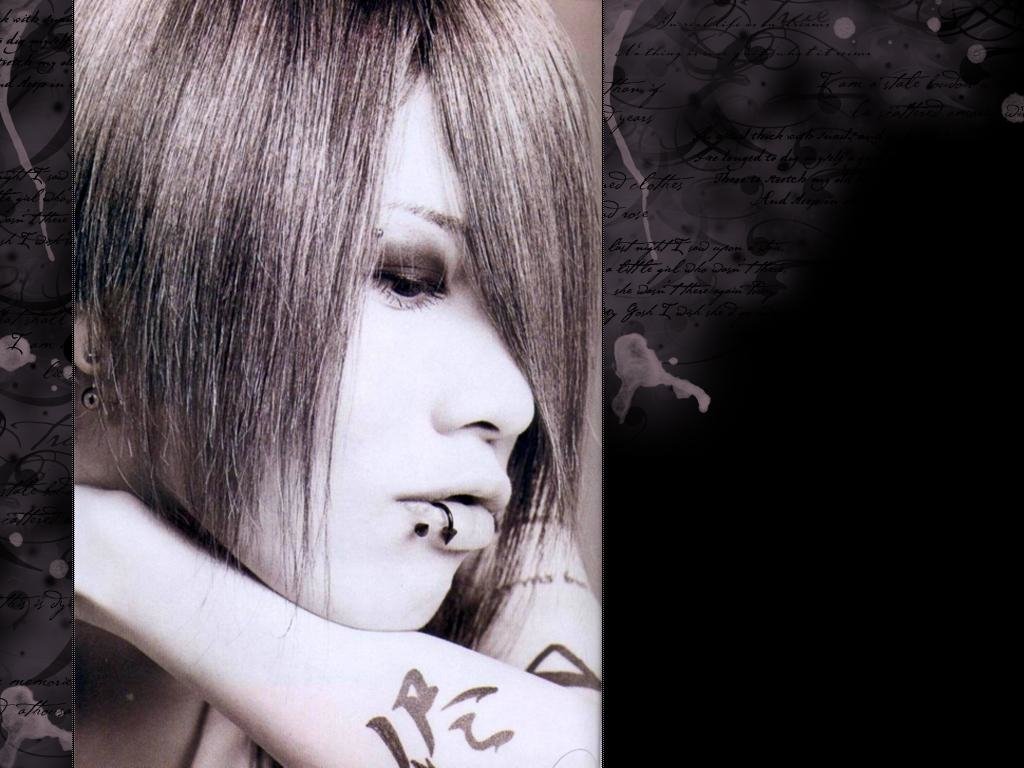 Close-up profile of J-Rock artist Miyavi with piercings and tattoos, set against a dark, textured background evoking a moody, musical atmosphere.