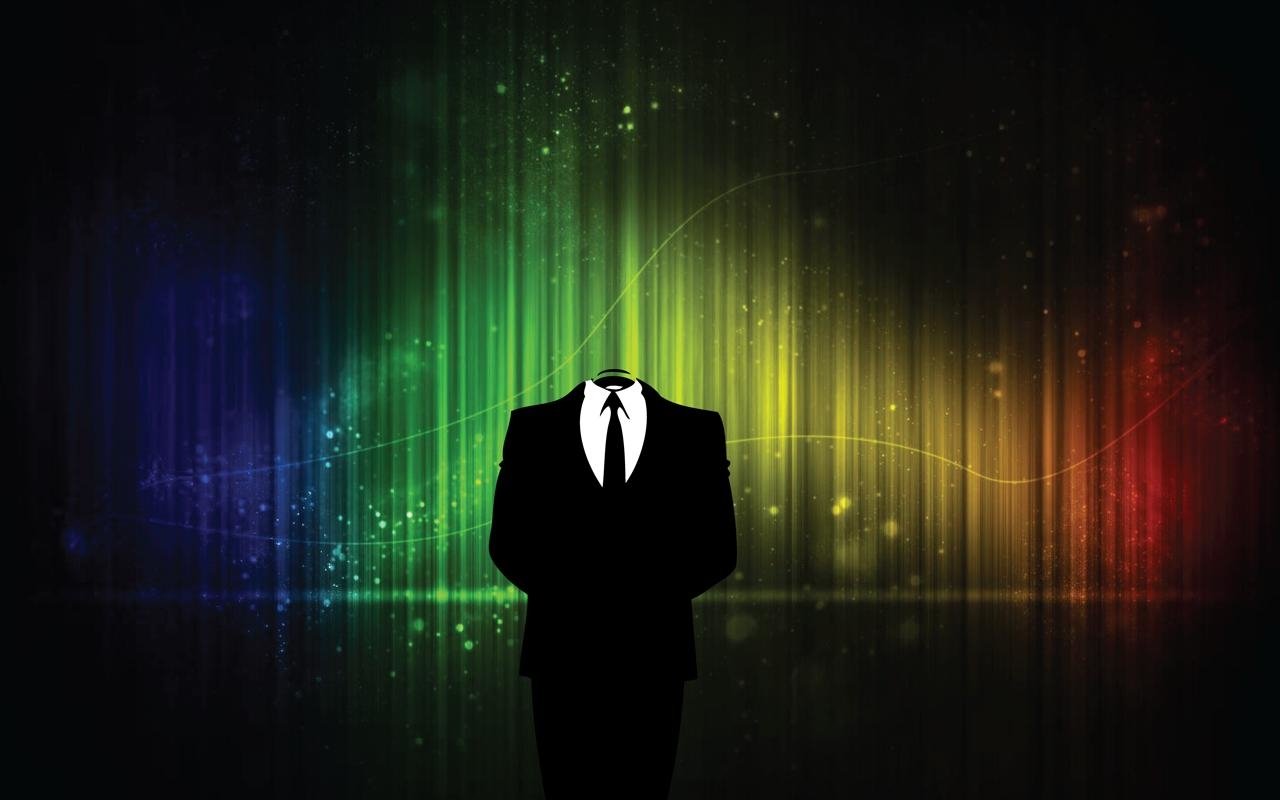 A faceless figure in a suit stands against a vibrant, colorful background, symbolizing technology and anonymity. The image conveys a sense of mystery and digital presence.
