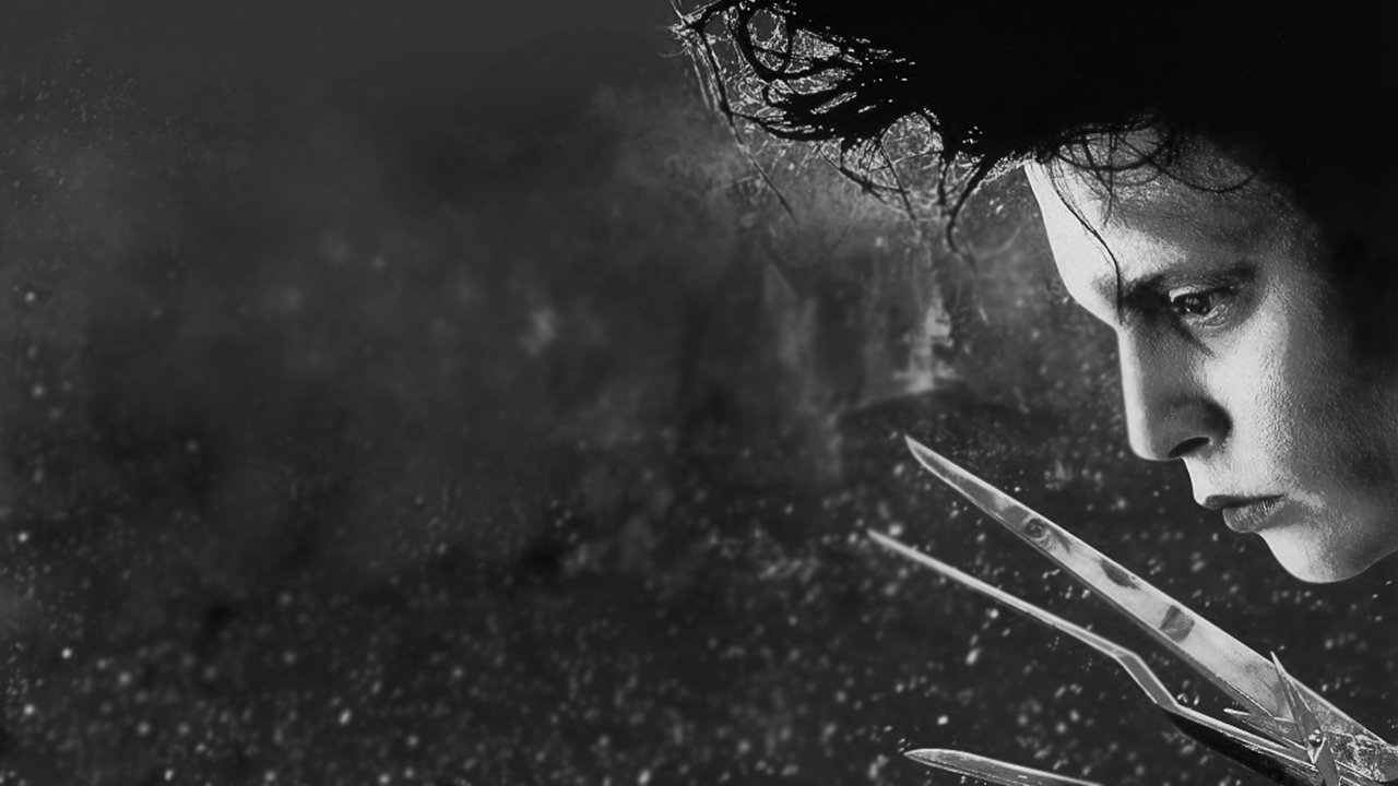 Johnny Depp as Edward Scissorhands, shown in a close-up black and white image highlighting his scissor-like hands and contemplative expression.