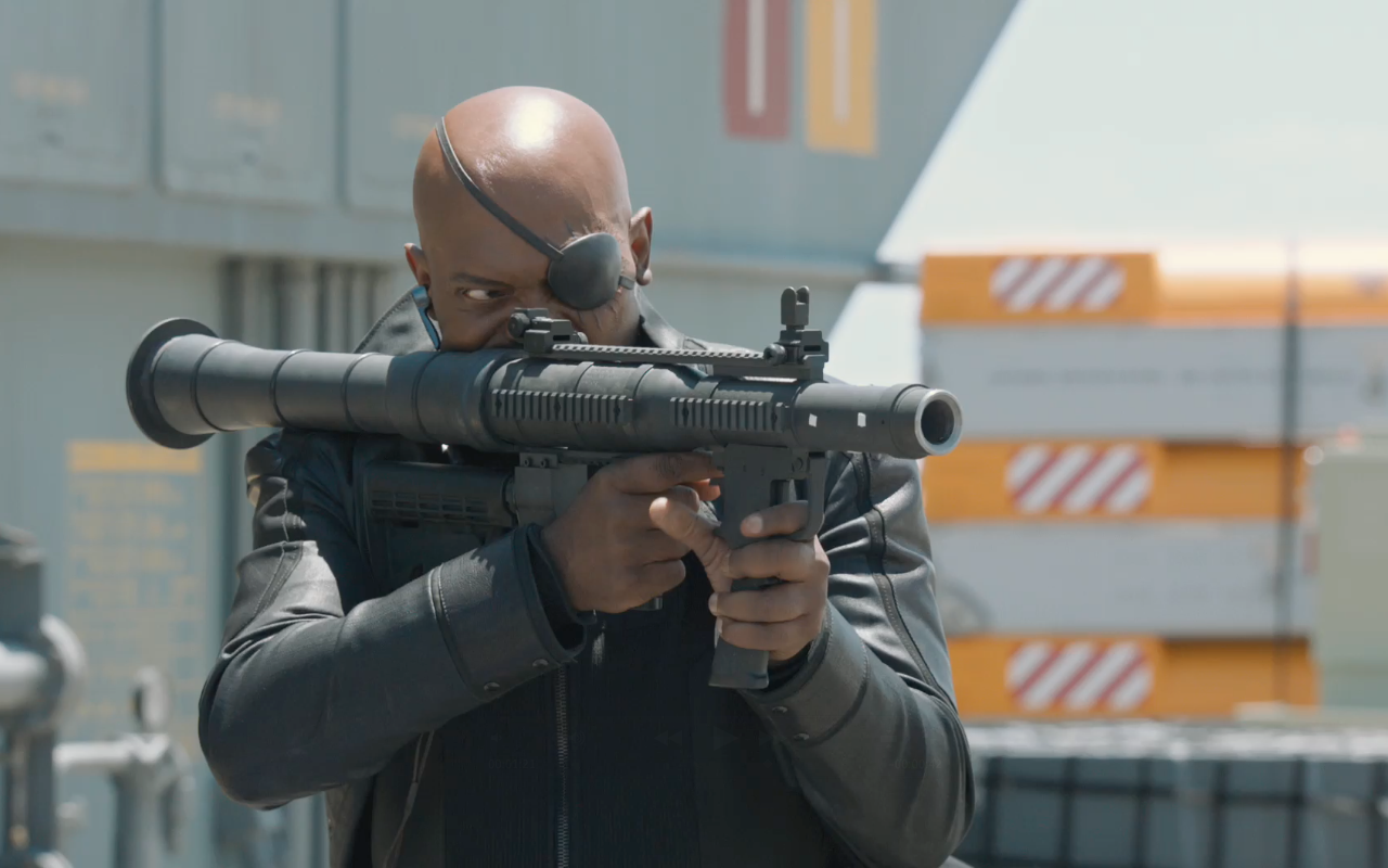 Samuel L. Jackson as Nick Fury from the Avengers movie, aiming a high-powered rifle in a tense action scene.
