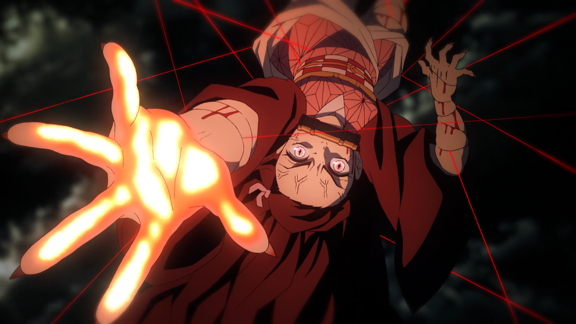 A tense scene from the anime Demon Slayer: Kimetsu no Yaiba shows a character trapped in glowing red threads, reaching out with a desperate expression.