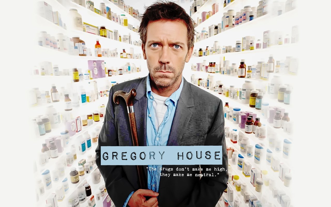 Gregory House (TV show House) in a suit holding a cane amid shelves of medication, staring intensely at the viewer.