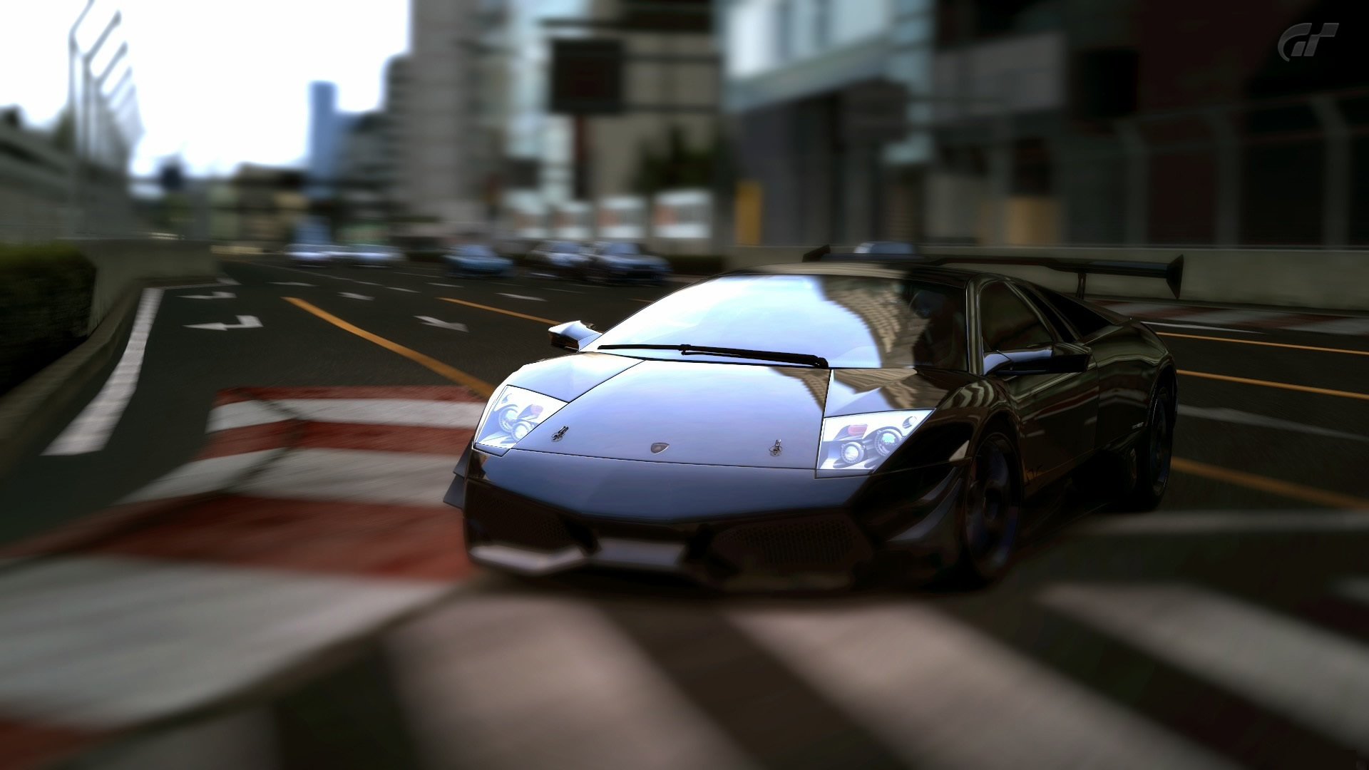 A sleek black Lamborghini Murcielago races through a city street, showcasing its aerodynamic design and powerful presence on the track.