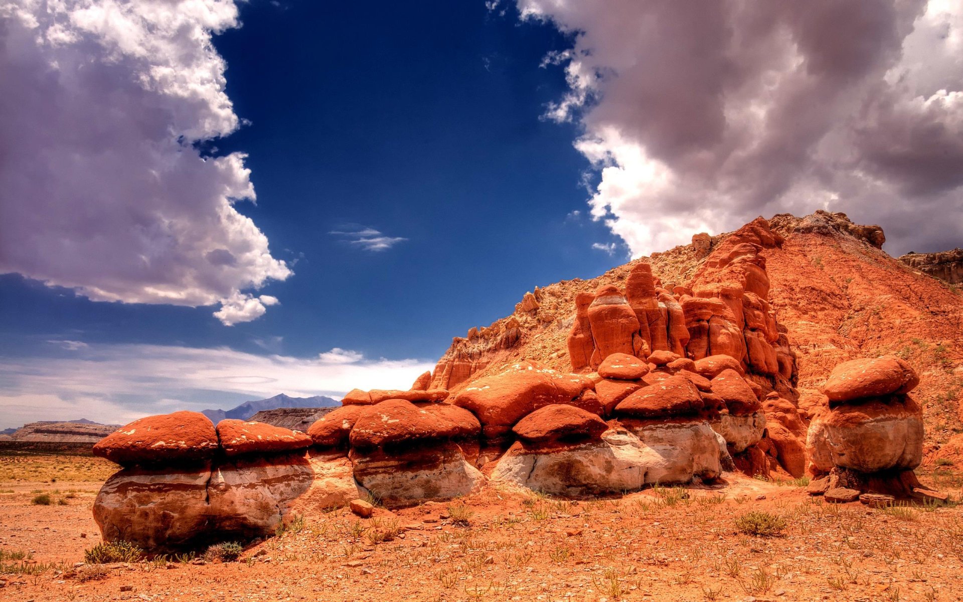 A striking natural rock formation under a partly cloudy sky in a rugged landscape.