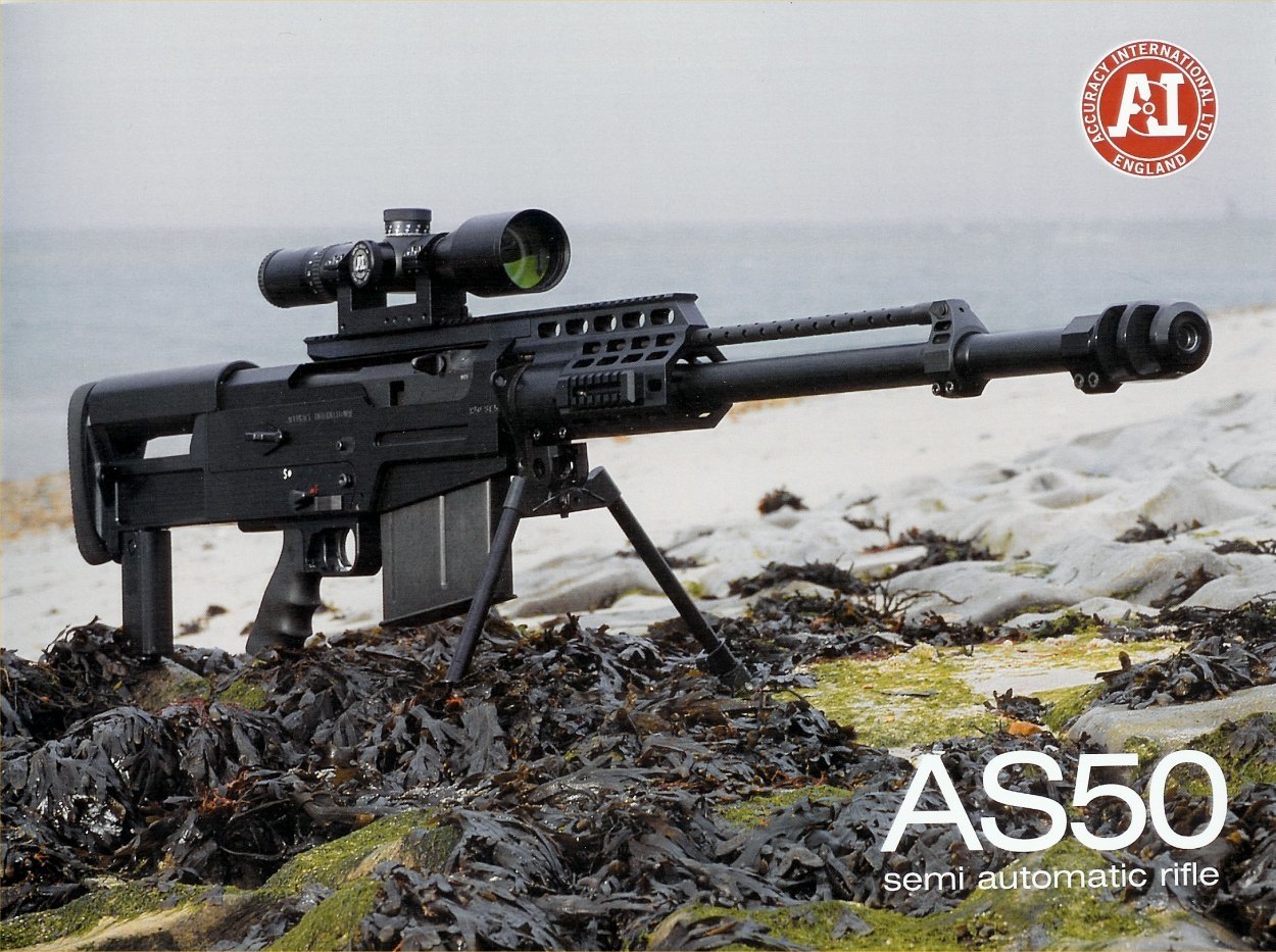 A semi-automatic AS50 sniper rifle rests on the ground, surrounded by seaweed, with a scenic beach in the background.