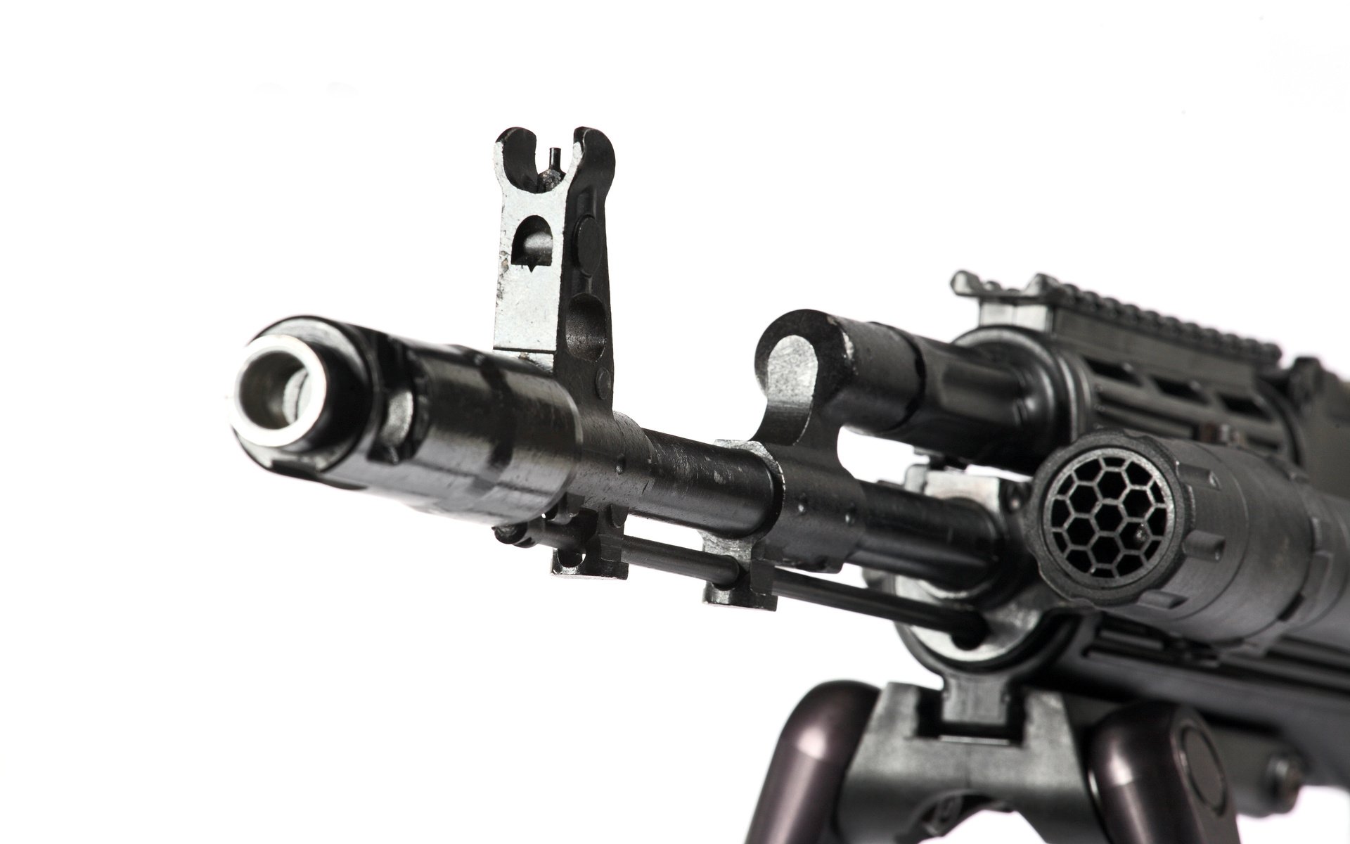 Close-up view of a man-made machine gun barrel with a bipod stand, isolated on a white background.