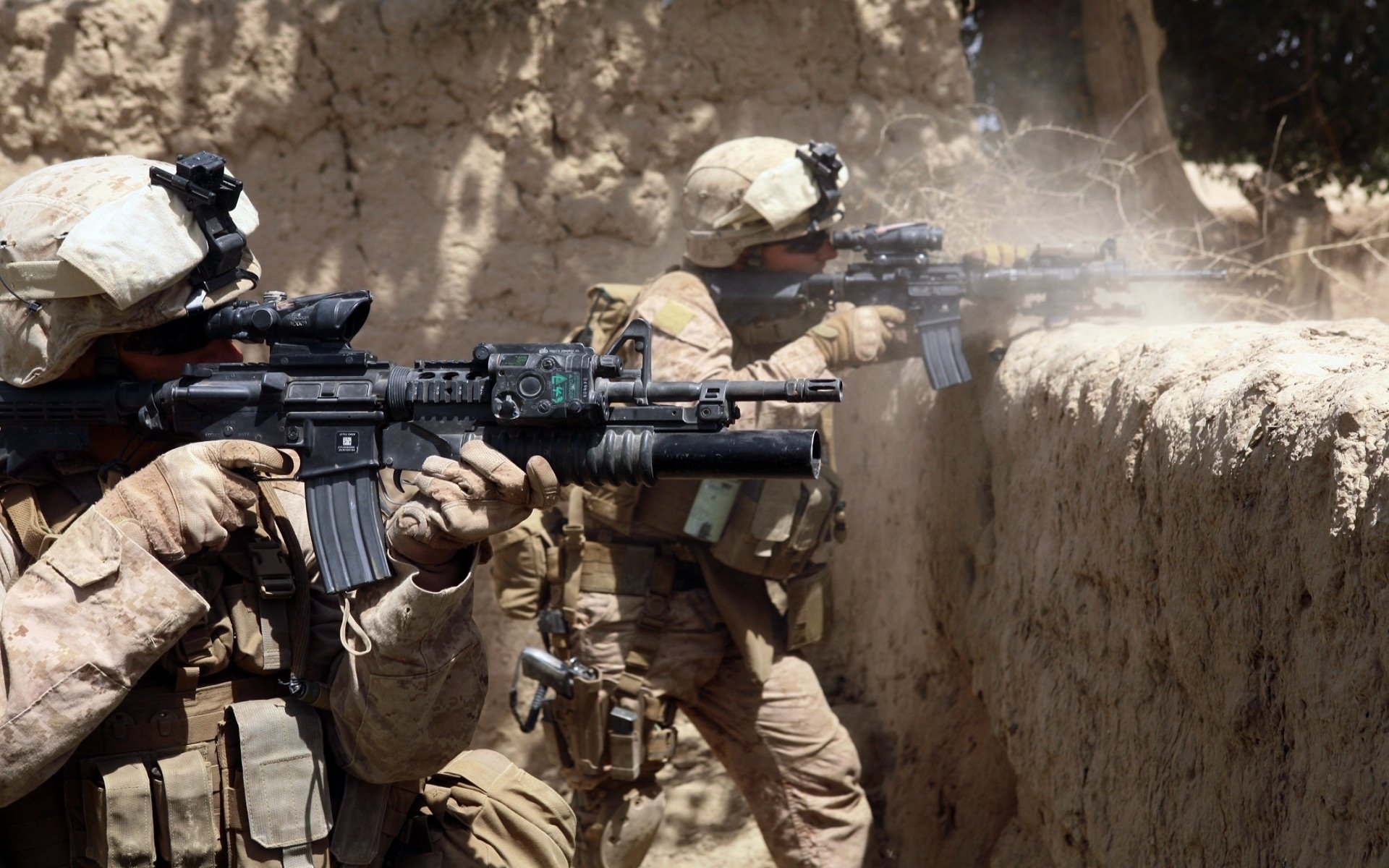 Two U.S. Army Infantry soldiers take cover behind a wall, aiming their weapons in a military operation, showcasing their tactical skills and use of firearms.