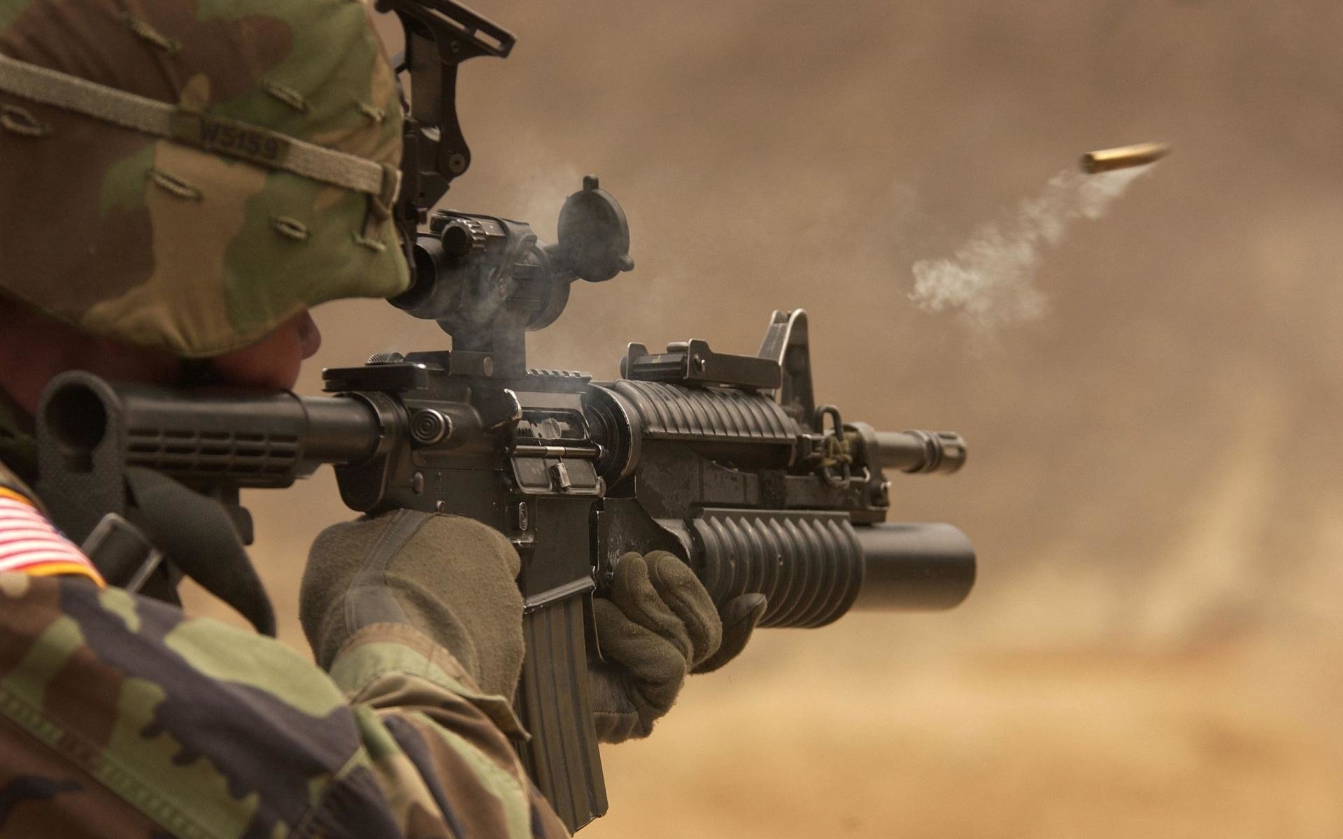 A soldier in military gear fires a rifle, with a bullet casing ejected in the air, showcasing the intensity of firearm training or combat readiness.