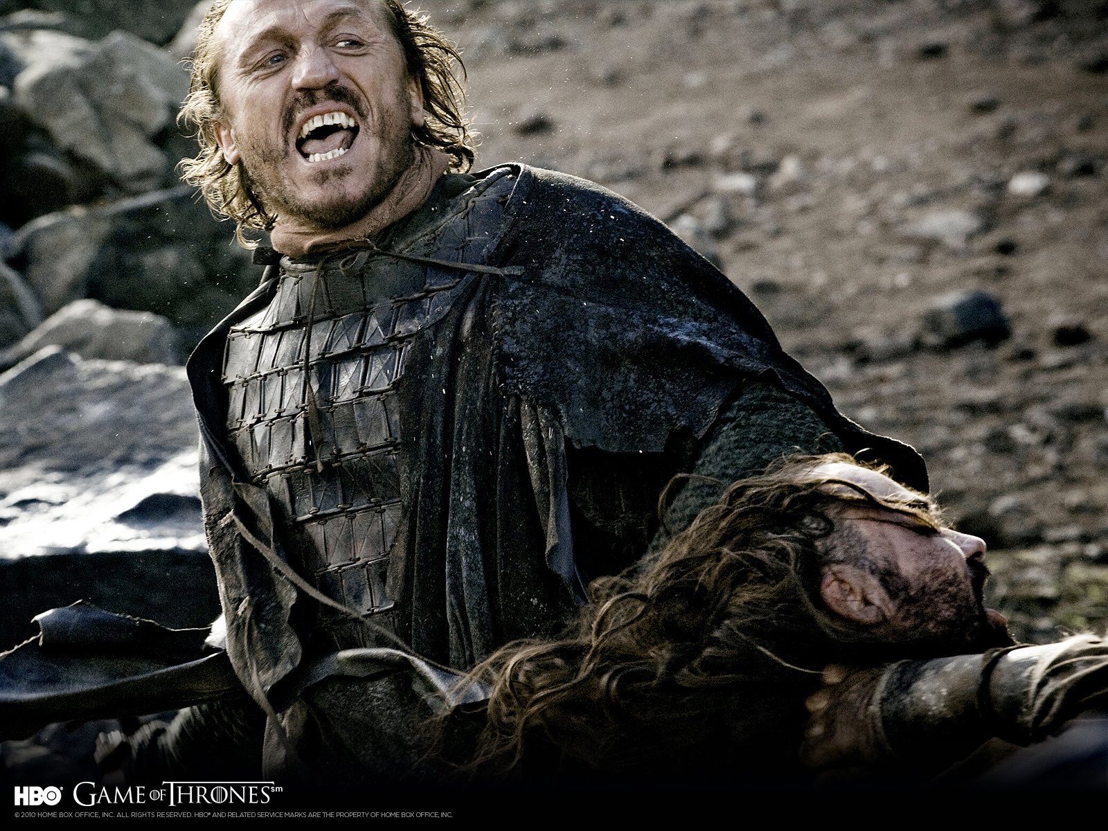 A dramatic scene from the TV show Game of Thrones, featuring a character in battle gear, triumphantly holding a defeated foe while expressing raw emotion.