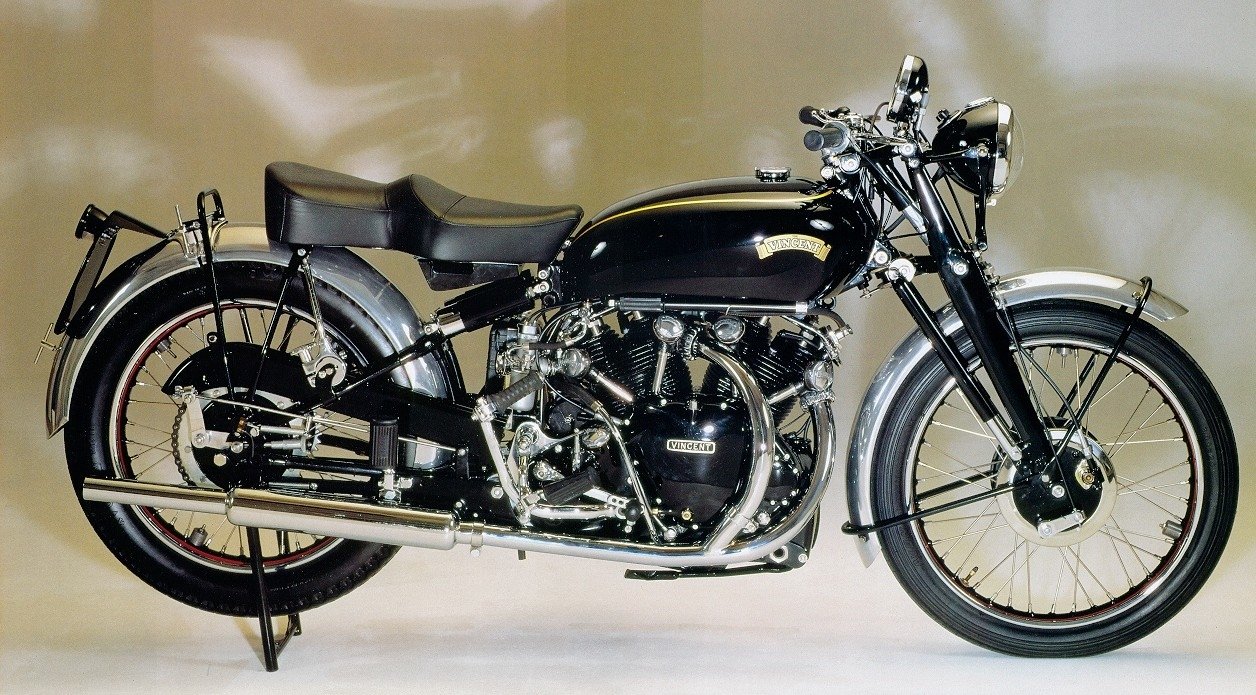 Side view of a 1950 Vincent HRD Black Shadow motorcycle — black and chrome finish, exposed V-twin engine, rigid frame, single saddle and twin exhausts.