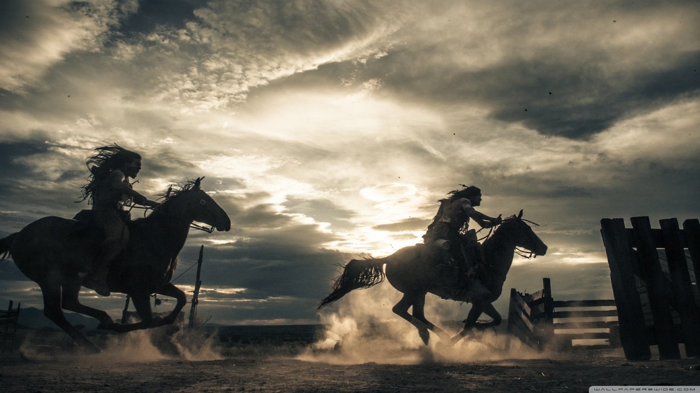 Two cowboys ride horses at full gallop, kicking up dust against a dramatic sky, capturing the adventurous spirit of the movie The Lone Ranger.