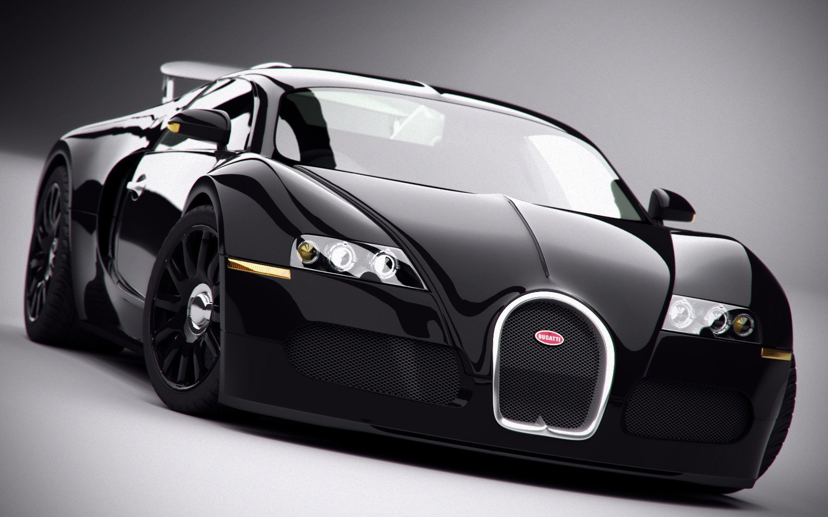 A sleek black Bugatti Veyron vehicle shown from a low front angle, highlighting its aerodynamic design and distinctive rounded grille.