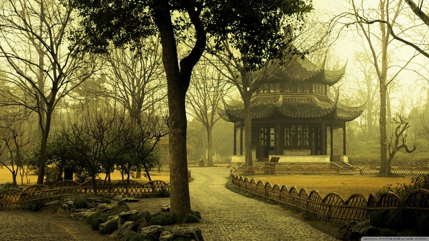 A serene park scene featuring a traditional pavilion surrounded by bare trees and a winding path, captured with a warm, golden atmosphere and soft light.