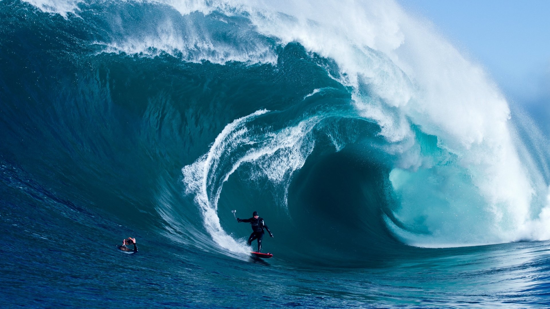 A surfer rides a massive wave, showcasing skill and balance in an intense moment of the sport of surfing.