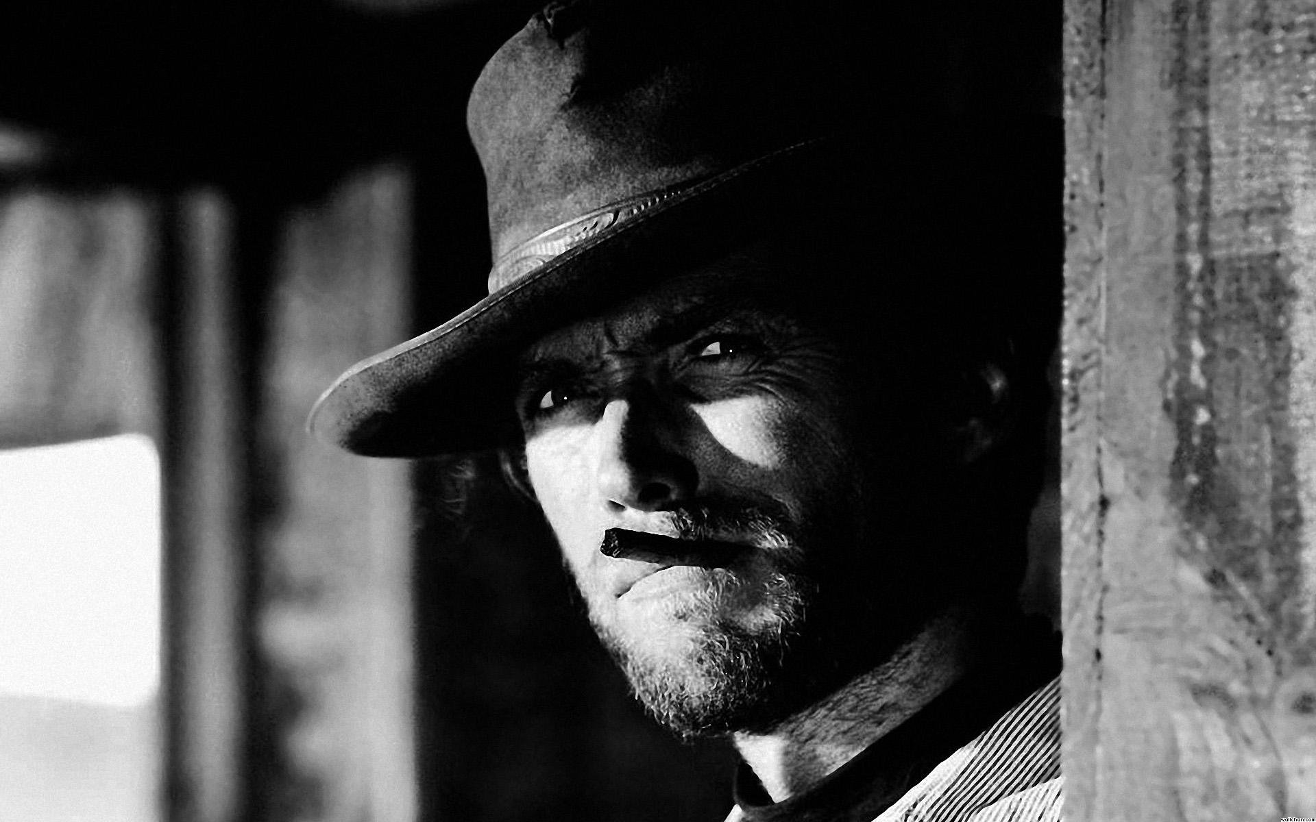 A close-up of Clint Eastwood in a classic black-and-white scene from the movie *The Good, the Bad and the Ugly*, showcasing his iconic look with a hat and intense expression.
