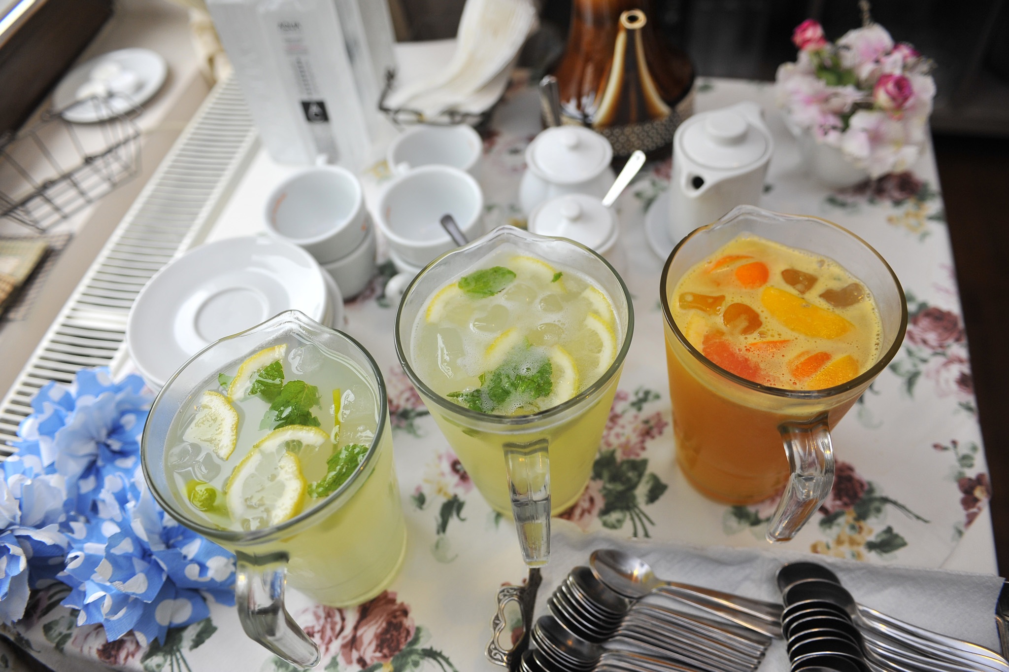 Jugs of lemonade and fruit cocktail drinks by danabosincianu