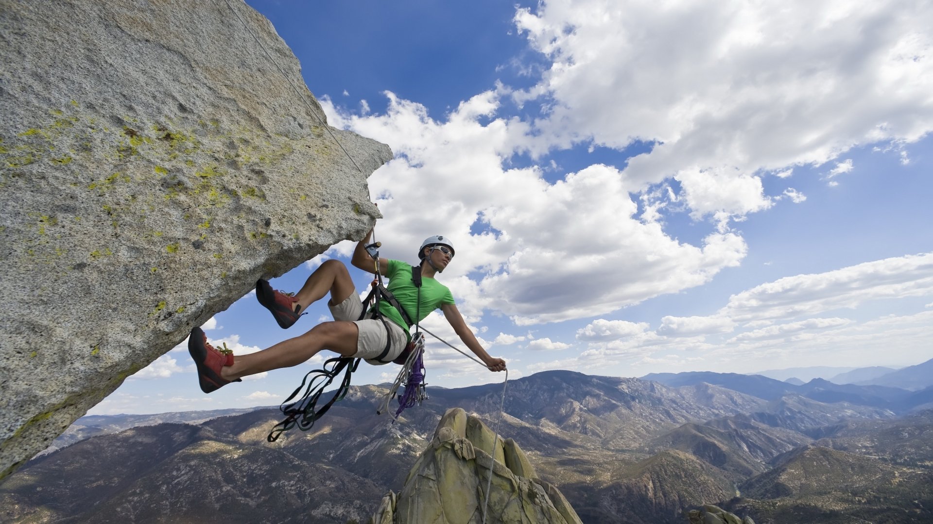  a human fly climbing an overhanging cliff