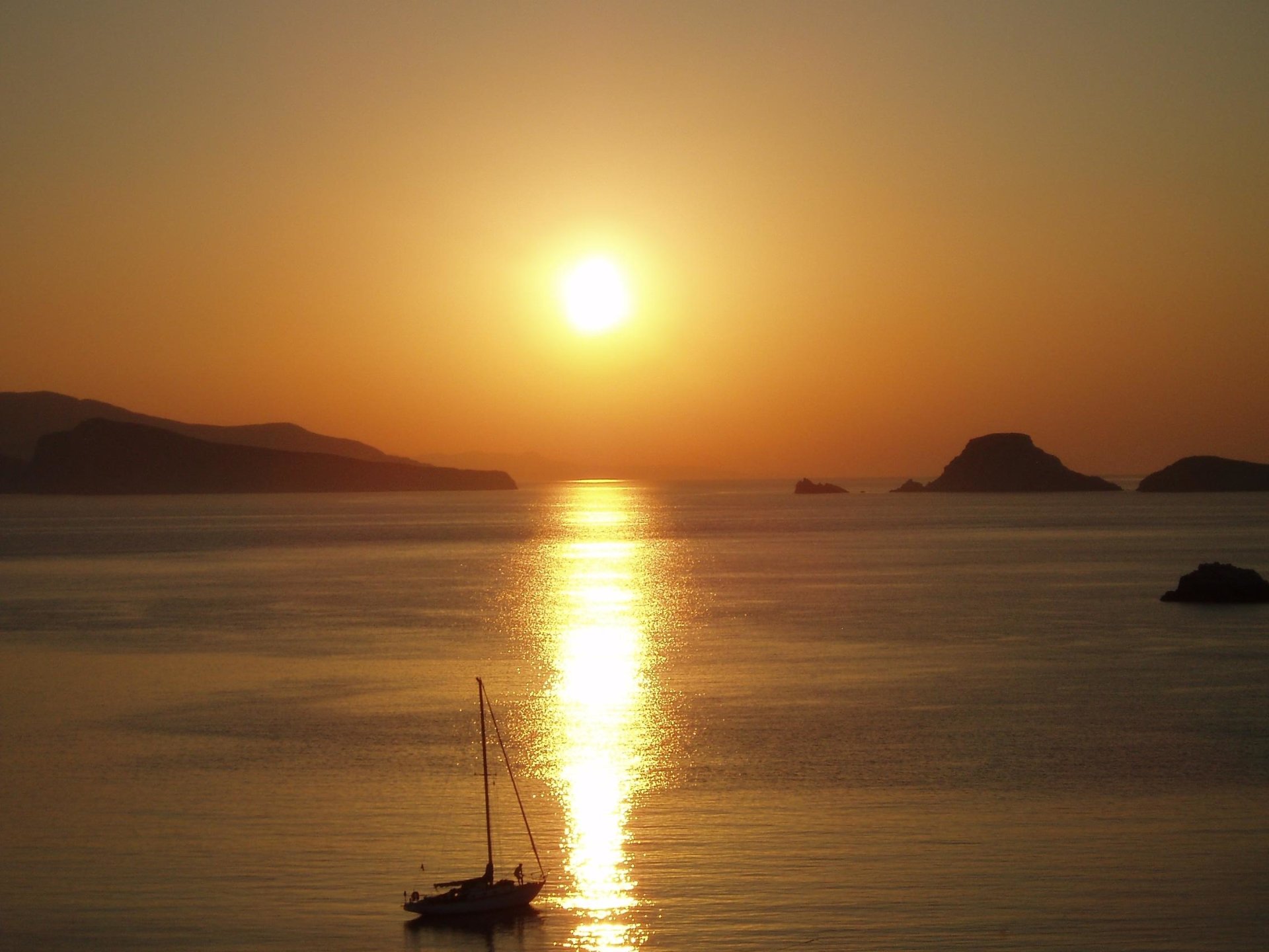  Early morning sunrise in the bay with a sail boat