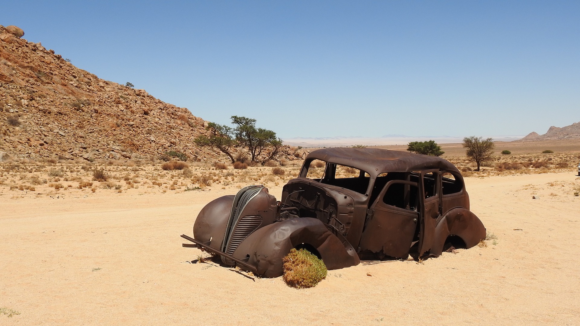 Rusty old wrecked car in the  Kalahari Desert, Africa by Stephan Weyer