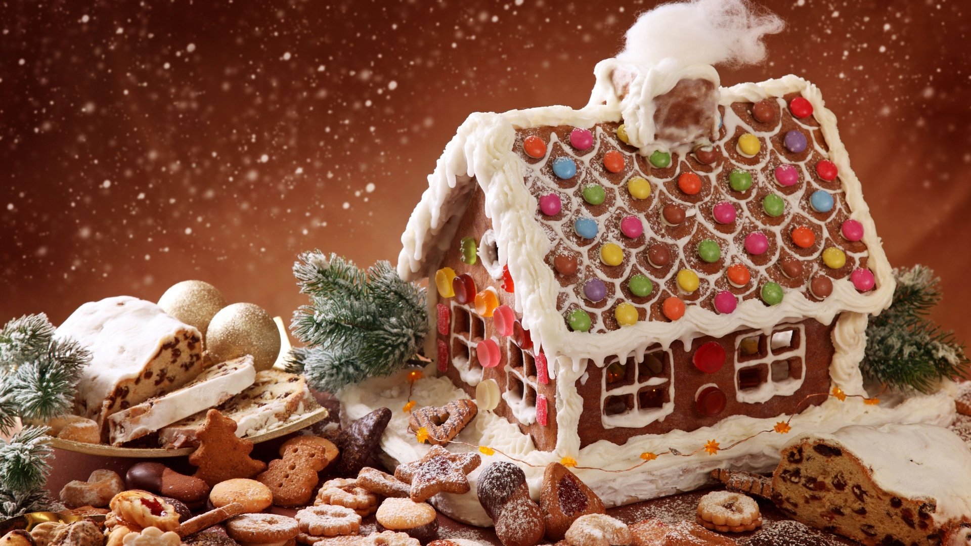 A festive Christmas scene featuring a colorful gingerbread house adorned with candy, surrounded by an array of cookies and holiday treats, all set against a snowy backdrop.
