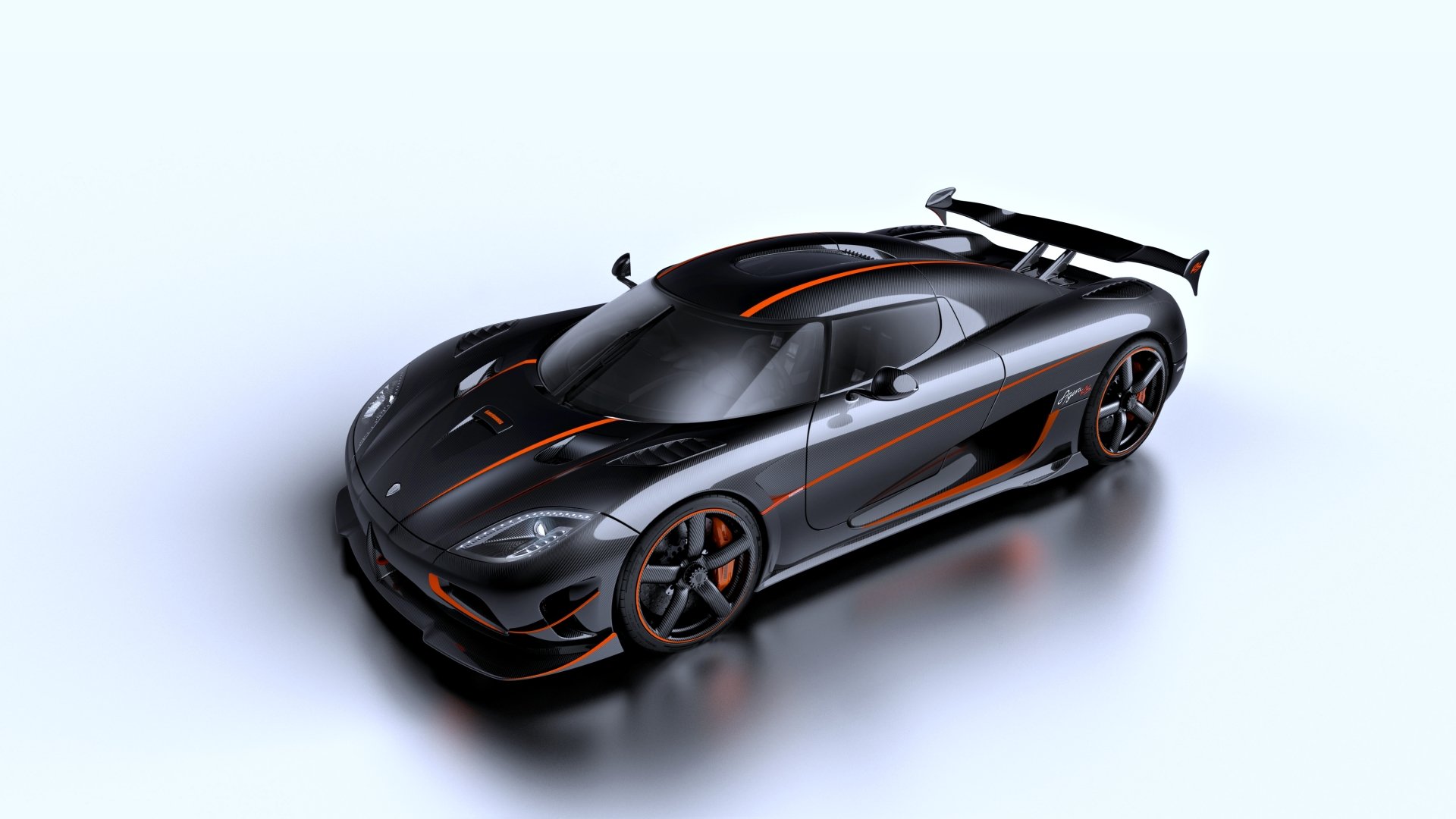 Sleek black Koenigsegg Agera RS hypercar with aerodynamic design and bold orange accents, showcasing its powerful and futuristic vehicle stance.
