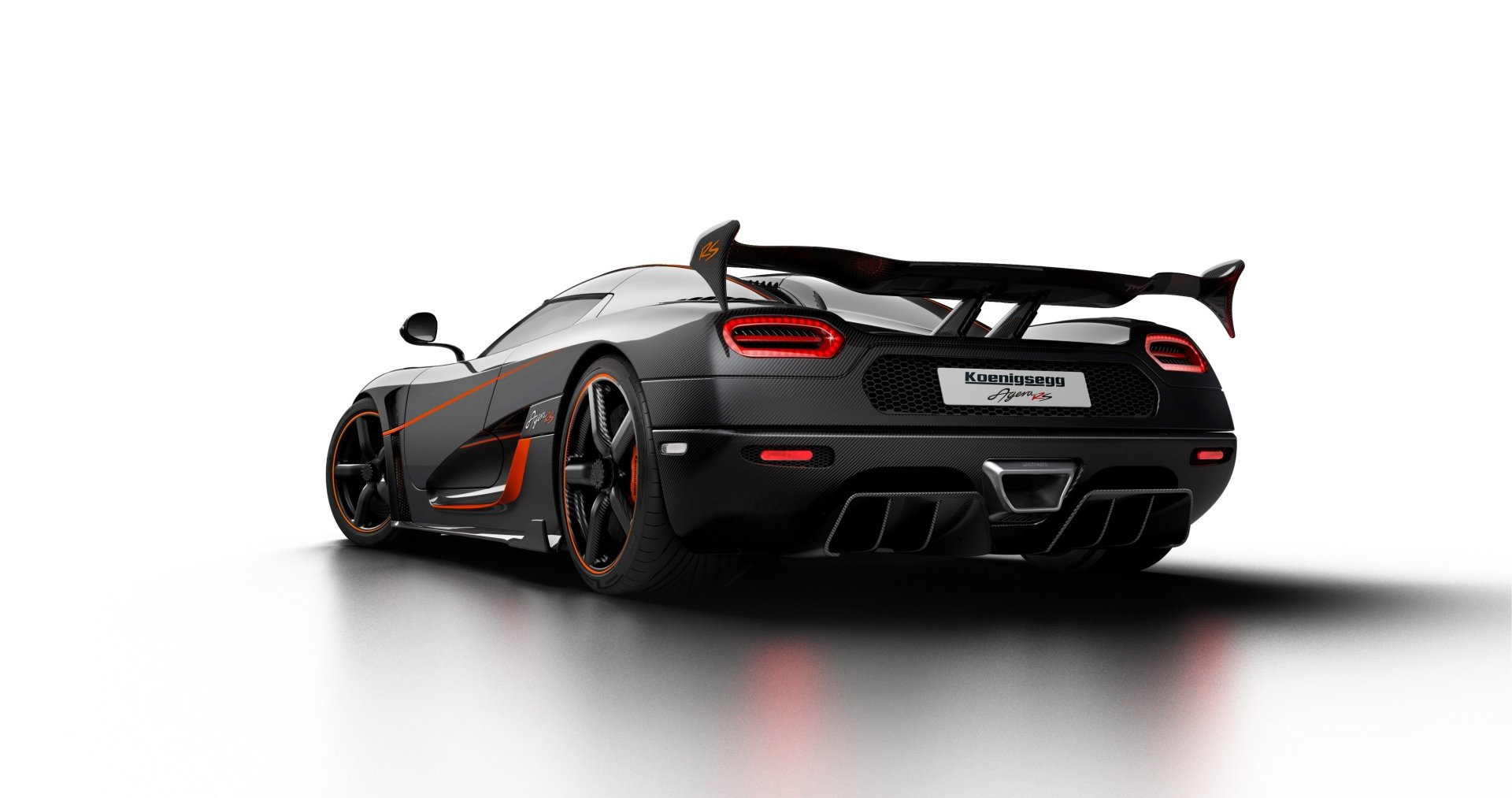 A sleek black Koenigsegg Agera RS hypercar showcases its aerodynamic design and powerful stance, highlighted by a distinctive rear wing and striking details.