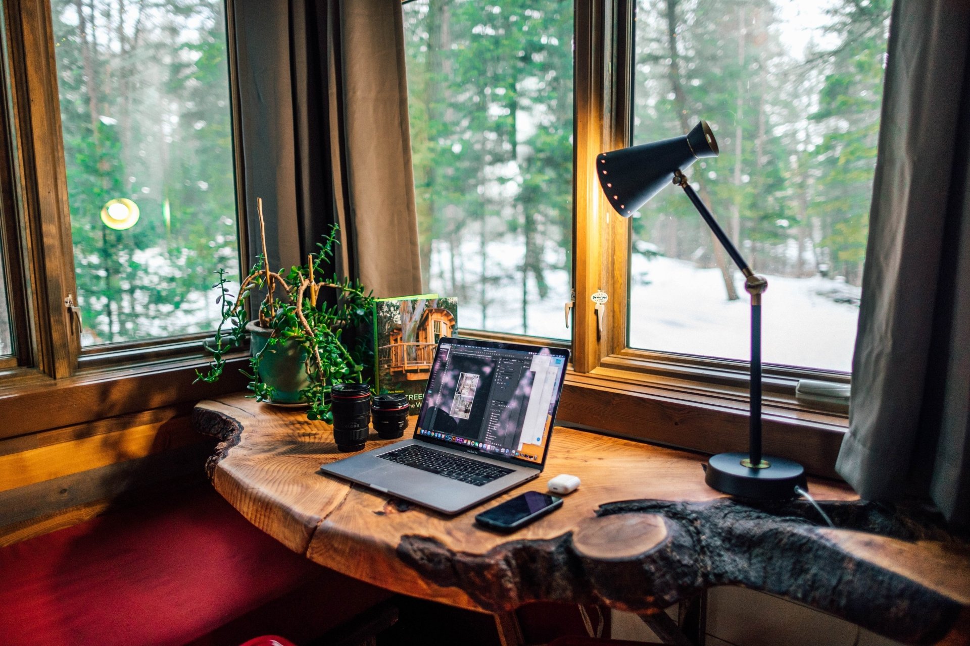  Macbook Pro and Camera Lenses on a Wooden Table by Roberto Nickson