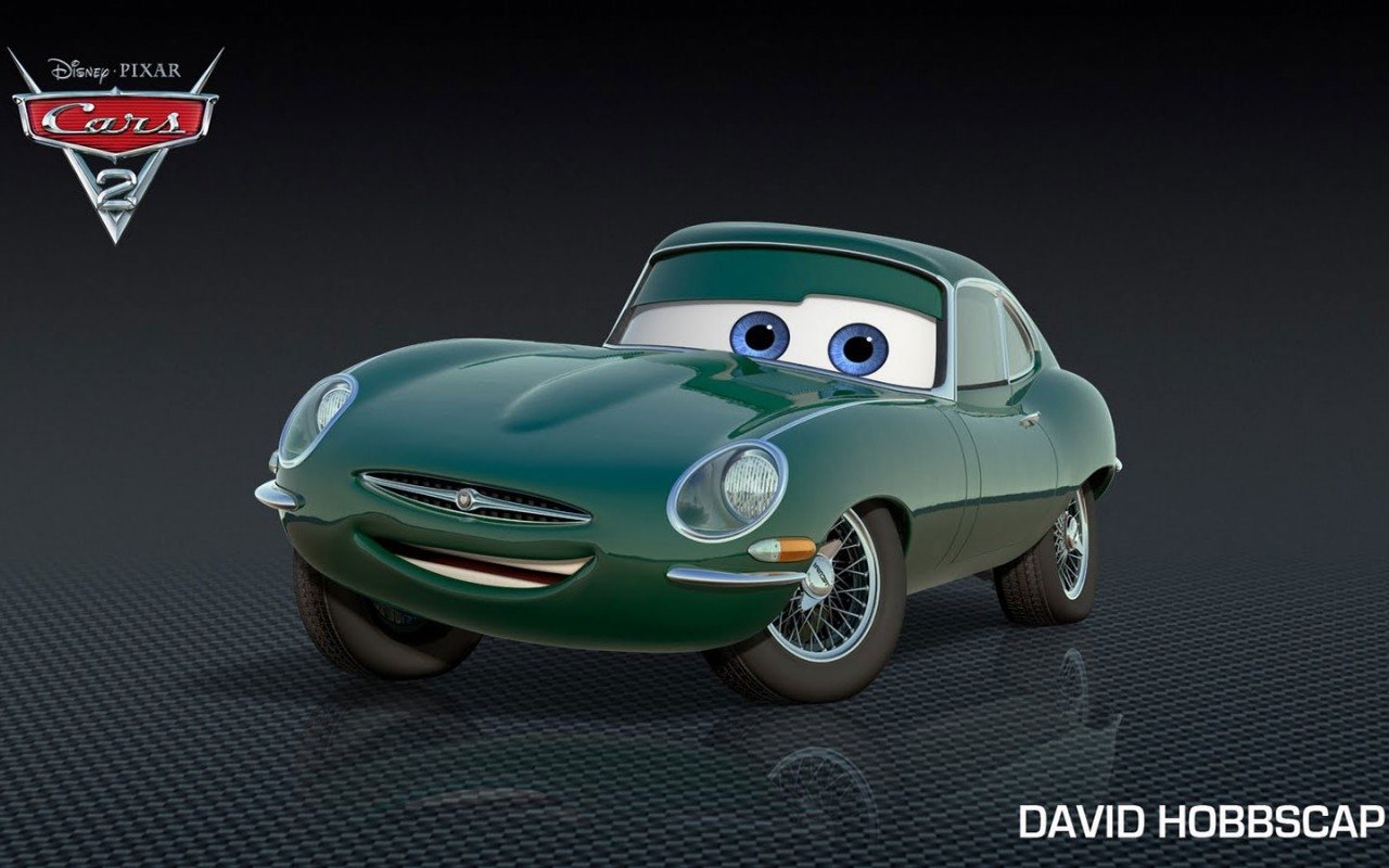 David Hobbscap, a green classic sports car character from the movie Cars 2, smiling with blue eyes against a dark textured backdrop.