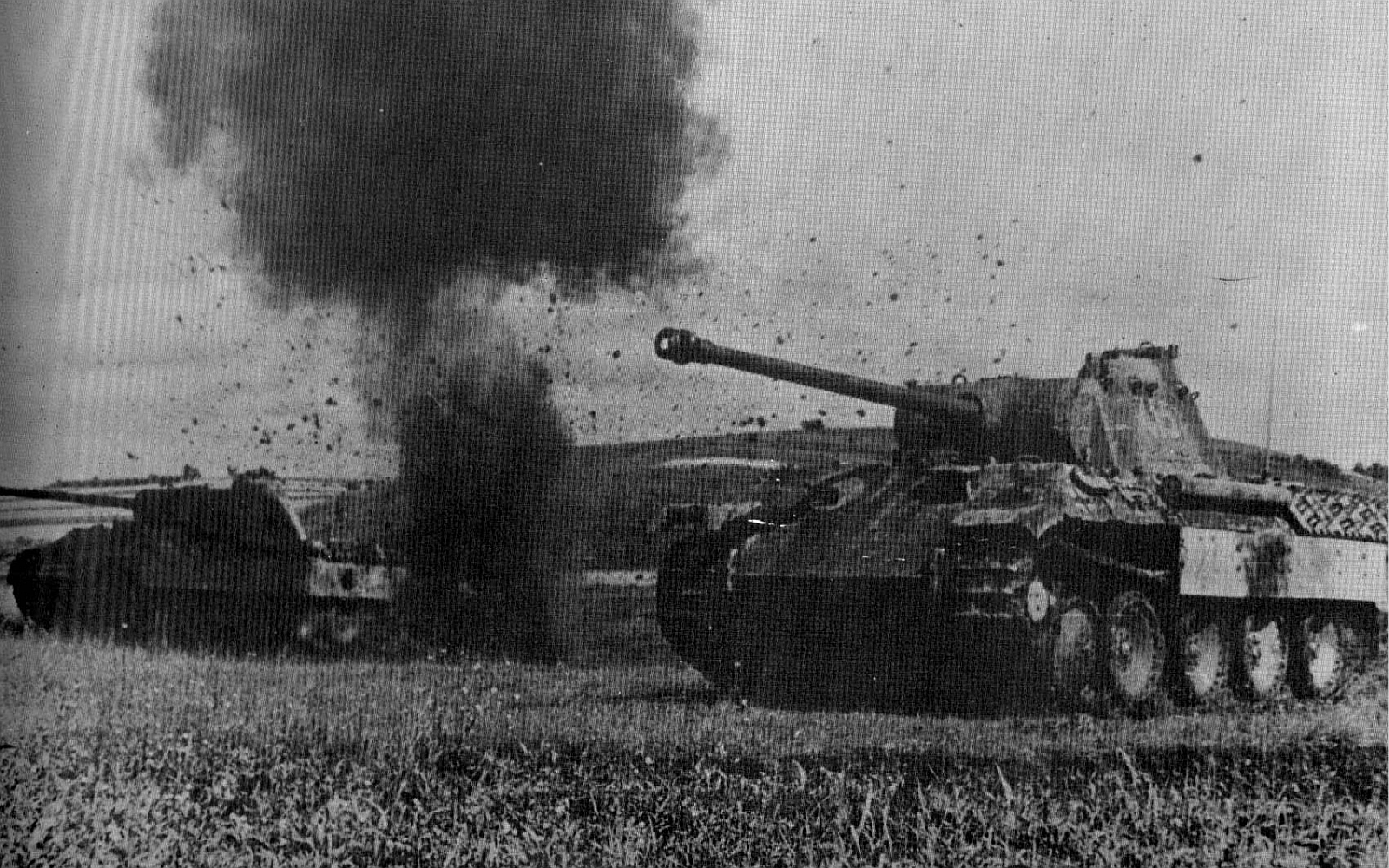 A pair of German Panther Advance thought multiple artillery strikes.