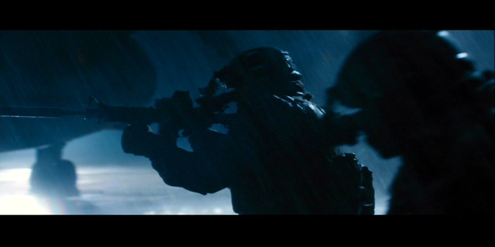 Scene from the movie World War Z showing silhouetted soldiers in tactical gear holding weapons against a dark, foggy background.