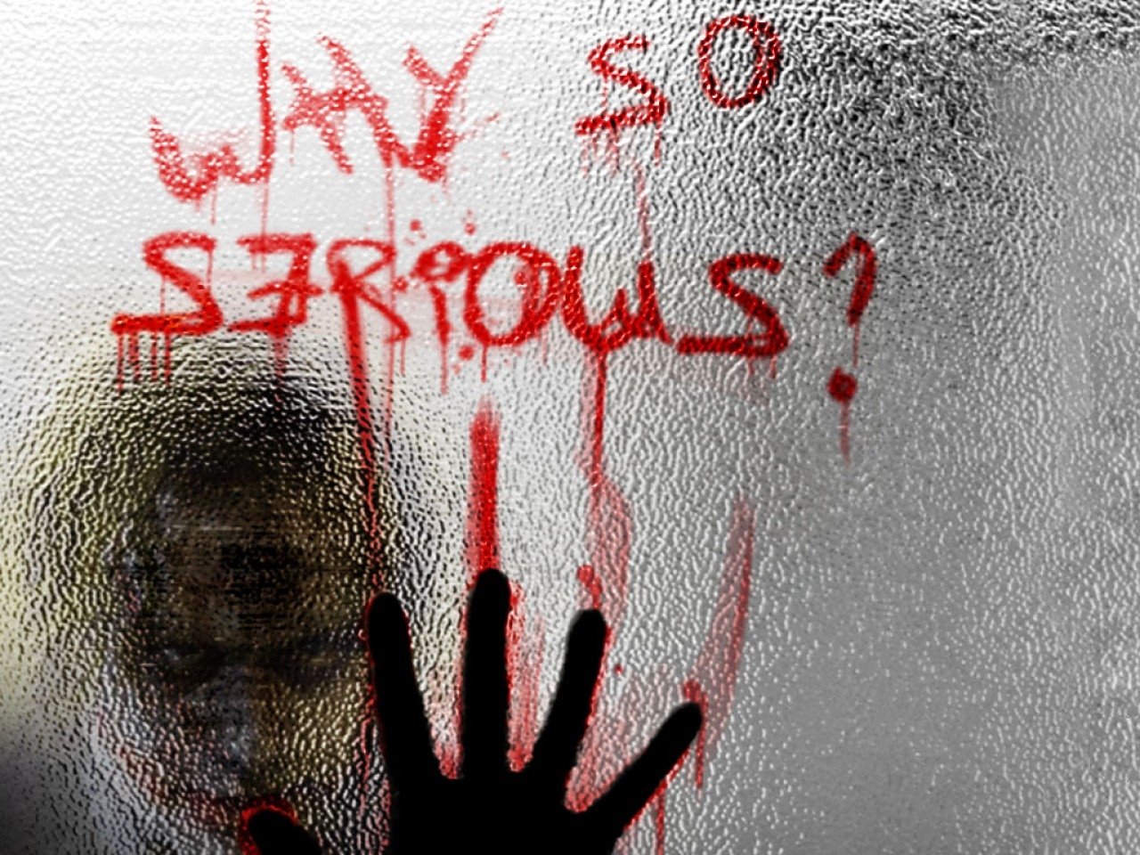 A handprints on a foggy surface, with Why so serious? written in red, evokes the menacing tone of the Joker from the movie The Dark Knight.