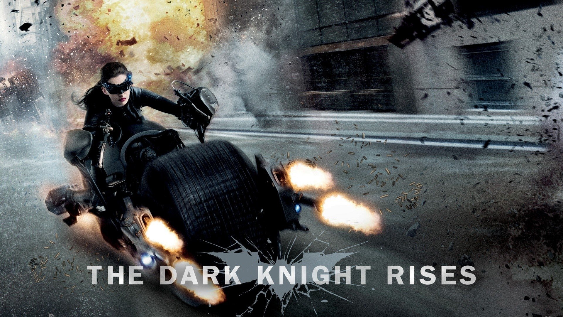 Action scene from the movie The Dark Knight Rises showing a character riding a Batpod motorcycle with explosions and debris flying in the background.
