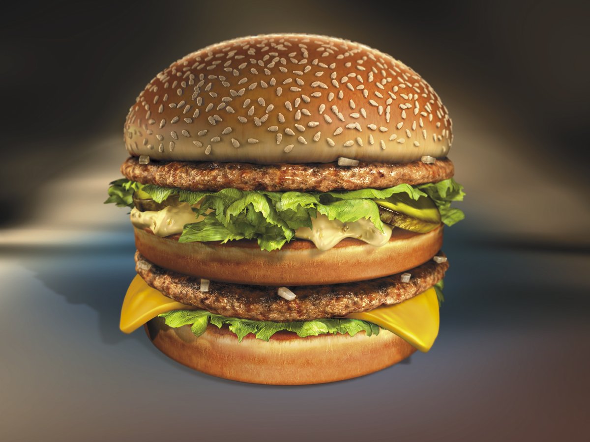 A close-up of a delicious burger featuring two meat patties, crisp lettuce, creamy sauce, and a slice of cheese, all held snugly between a sesame seed bun.